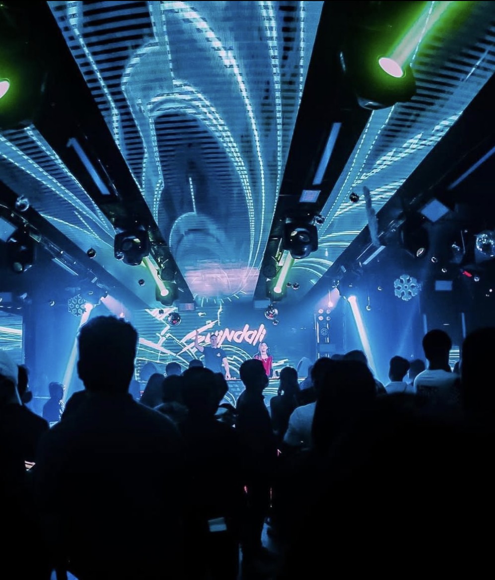 Swindali performing in a blue-lit club