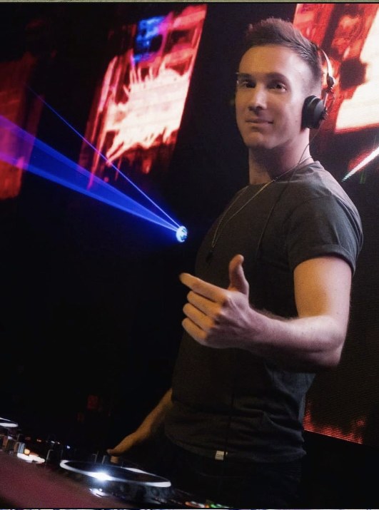 Swindali at the DJ booth with lasers